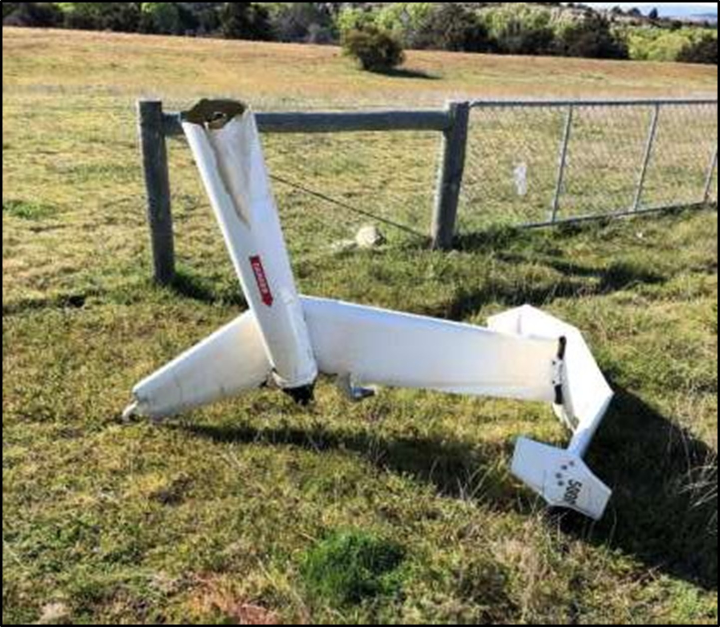2.40.	A large part of the tail rotor and gearbox assembly was found approximately 100 m forward (north) of the main wreckage. A section of a main rotor blade tip (about 450 mm in length) was found nearby. Small fragments of the tail rotor gearbox were found between the tail section and the main wreckage. Impact marks on the tail rotor blade and the tail rotor gearbox matched the profile of the leading edge of a main rotor blade. 2.41.	The tail boom had failed where it had been struck by a main rotor. The tail section had separated and landed clear of the main wreckage. It was intact except for the missing tail rotor and gearbox assembly referred to above (see Figure 6).