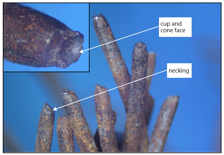 Macro photograph of the failed foot wire showing reduction (necking) and cup and cone failure face