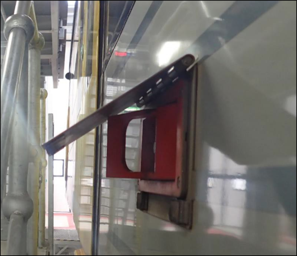 Emergency door release cover panel protruding from car