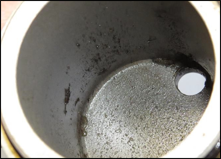 Fuel filter housing showing sludge residue