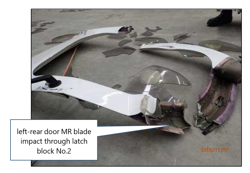 The image of the left-rear door-latching system to demonstrate the wear, the general condition and the free slack movement in the door-latch mechanism.