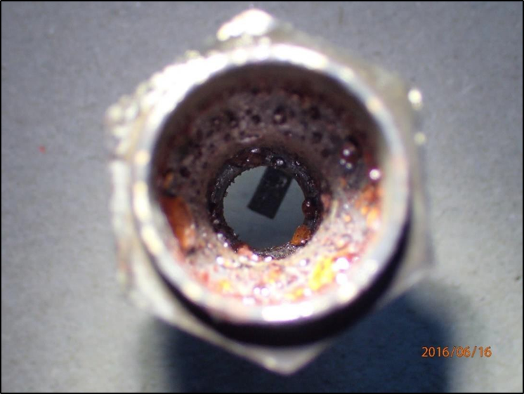 Aperture in failed spark plug shell