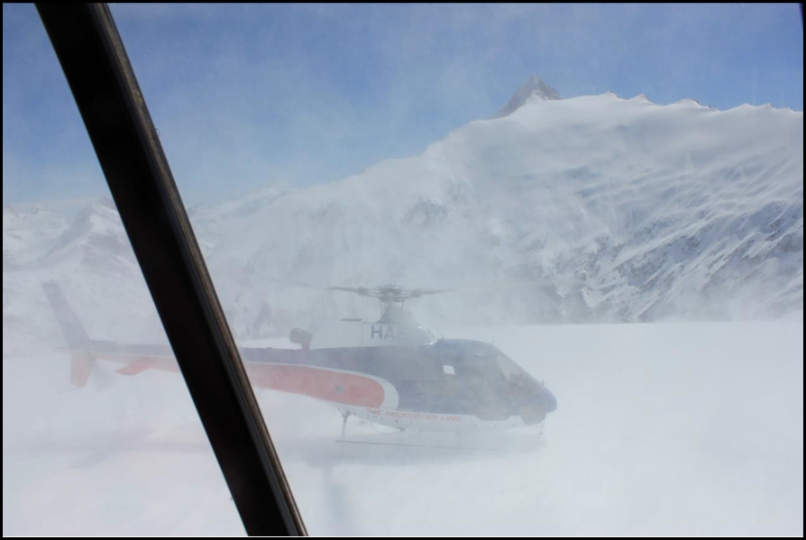 The parked helicopter as seen on the go-around from first approach (Still photograph taken by a passenger)