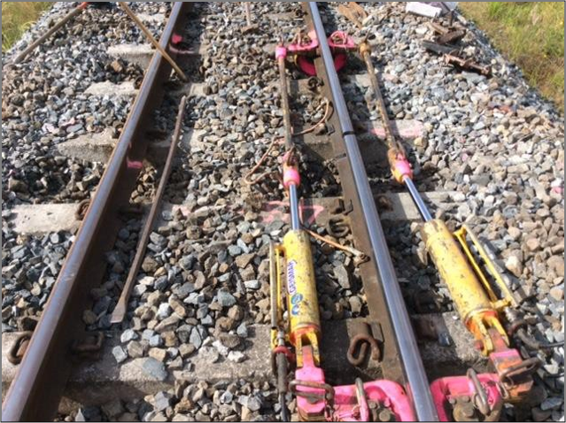 An example of rails being pulled together during a de-stressing operation