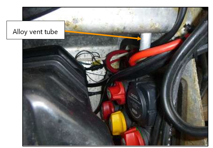 2021 survey photo demonstrating restricted view of alloy vent tube with batteries in place.