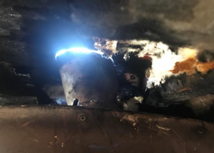 Photo showing daylight visible where exhaust tail pipe met ceiling of AG130