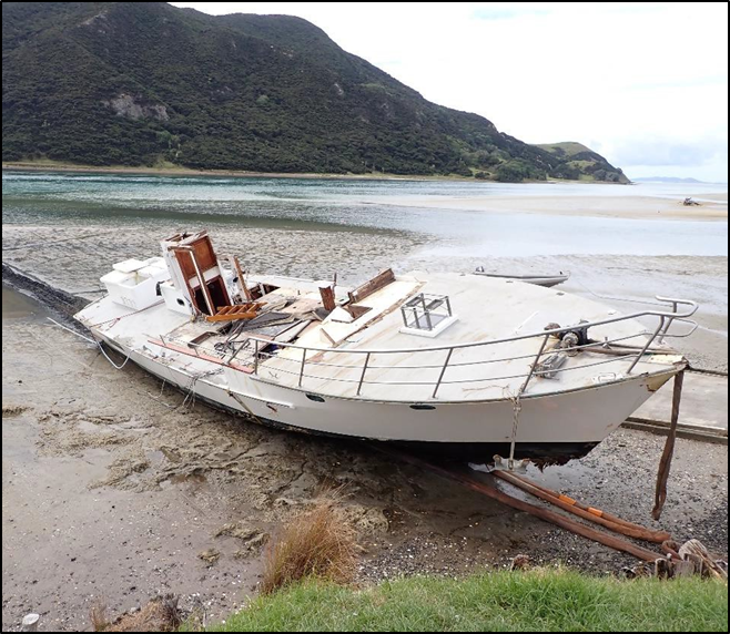 The Enchanter’s hull on the beach at Houhora Heads