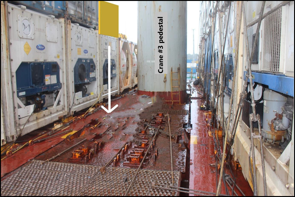 View from where the vessel crew member was standing on the main deck towards where hold operator A fell, as indicated by white arrow. Yellow box represents where the container was to be positioned