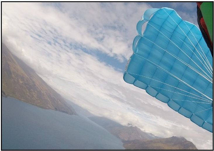Photo from the accident flight video showing the reserve canopy spinning at about 1,400 feet (420 m)