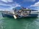 close-up photo of the Blue Ferry after the accident. The midships port side is catastrophically smashed up and in splinters, including the wheelhouse. 