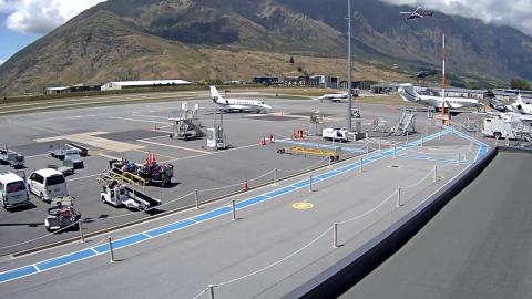 Photo across Queenstown Airport's Southern Apron with the two helicopters airborne in the middle distance