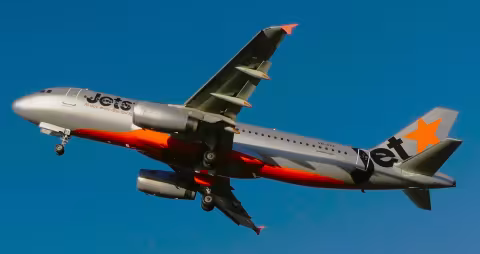 The incident aircraft, a Airbus A320 passenger jet viewed at low altitude from below with its landing gear down